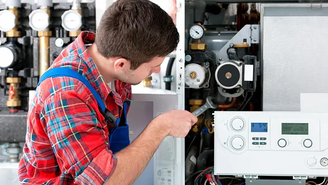 A plumber repairing a boiler