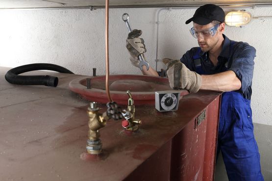 Man cleaning oil tank